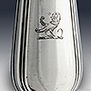Engraved lion crest on silver handle of cheese scoop