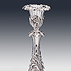 Floral detailing of the silver candlestick stem and candleholder with sconce