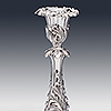Floral detailing of the silver candlestick stem and candleholder with sconce