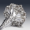 Top view of silver candlestick foot showing flora and fauna detailing
