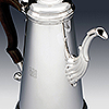 Side profile showing ornate spout detailing and engraved monogram
