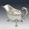 Side of silver sauce boat with swan handle profile
