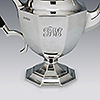 Side od silver teapot with hand engraved roman font monogram