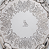 Detailed view of engraved pattern and owl crest to center of silver waiter